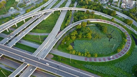 Aerial view of road interchange of highway intersection with traffic speeding 스톡 동영상 115486871