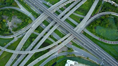 Aerial view of road interchange of highway intersection with traffic speeding 스톡 동영상 115490230