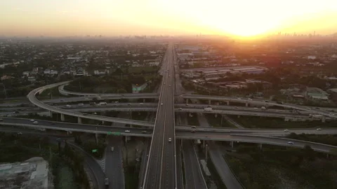 Aerial view of road interchange or highway intersection during sunrise Stock Footage 146615216