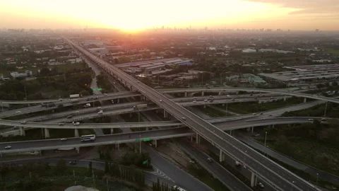 Aerial view of road interchange or highway intersection during sunrise Stock Footage 146617798