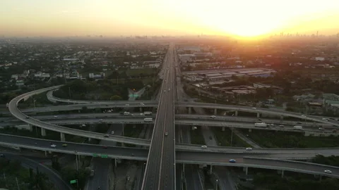 Aerial view of road interchange or highway intersection during sunrise Stock Footage 146619846
