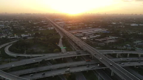 Aerial view of road interchange or highway intersection during sunrise Stock Footage 146620912