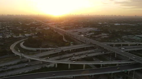 Aerial view of road interchange or highway intersection during sunrise Stock Footage 146621500