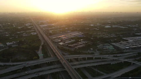 Aerial view of road interchange or highway intersection during sunrise Stock Footage 146622053