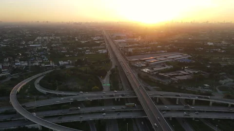 Aerial view of road interchange or highway intersection during sunrise Stock Footage 146622615