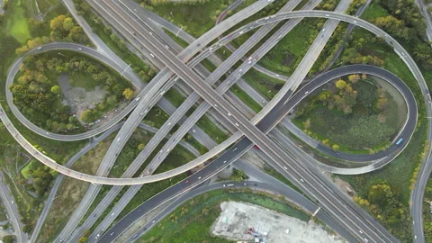 Aerial view of road interchange or highway intersection with cars speeding Stock Footage 146624139