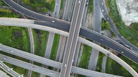 Aerial view of road interchange or highway intersection with cars speeding Stock Footage 146624322