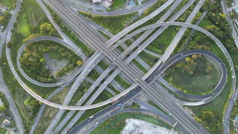 Aerial view of road interchange or highway intersection with cars speeding Stock Footage 146624632