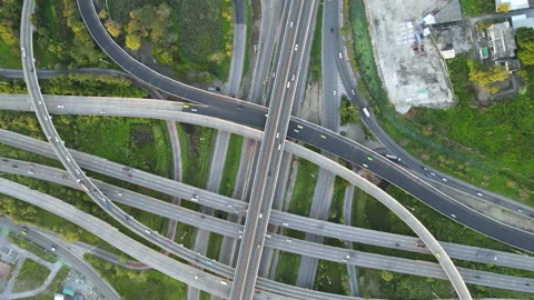 Aerial view of road interchange or highway intersection with cars speeding Stock Footage 146624715