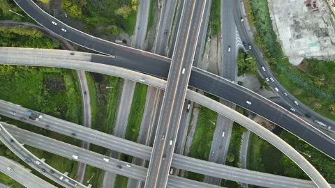 Aerial view of road interchange or highway intersection with cars speeding Stock Footage 146624820