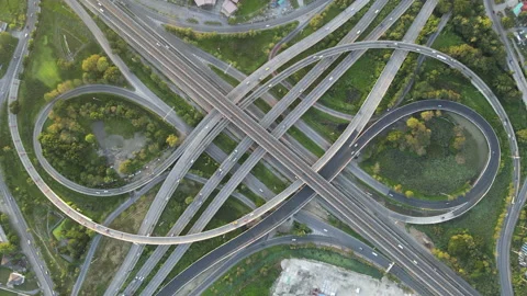 Aerial view of road interchange or highway intersection with cars speeding Stock Footage 146708071