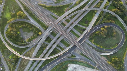 Aerial view of road interchange or highway intersection with cars speeding Stock Footage 147145289