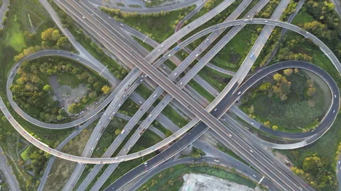Aerial view of road interchange or highway intersection with cars speeding Stock Footage 147145543