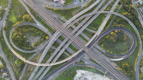Aerial view of road interchange or highway intersection with cars speeding Stock-Footage 147145666