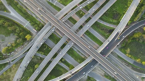 Aerial view of road interchange or highway intersection with cars speeding Stock Footage 147145789