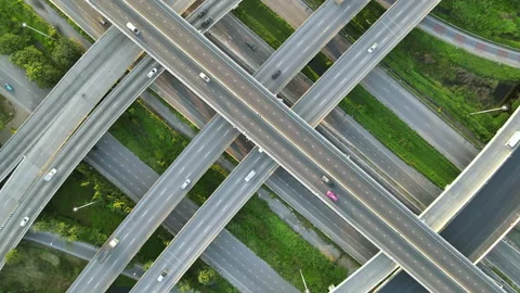Aerial view of road interchange or highway intersection with cars speeding Stock Footage 147145825