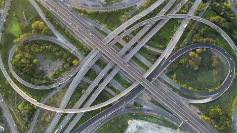 Aerial view of road interchange or highway intersection with cars speeding Stock Footage 147152658