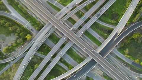 Aerial view of road interchange or highway intersection with cars speeding Stock Footage 147154652
