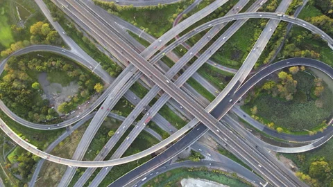 Aerial view of road interchange or highway intersection with cars speeding Stock Footage 147154676