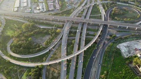 Aerial view of road interchange or highway intersection with cars speeding Stock Footage 147188183