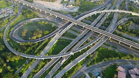 Aerial view of road interchange or highway intersection with cars speeding Stock Footage 147188192