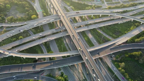 Aerial view of road interchange or highway intersection during sunrise Stock Footage 147193908