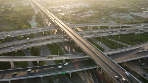 Aerial view of road interchange or highway intersection during sunrise Stock Footage 147199449
