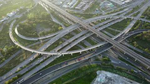 Aerial view of road interchange or highway intersection with cars speeding Stock Footage 147208247