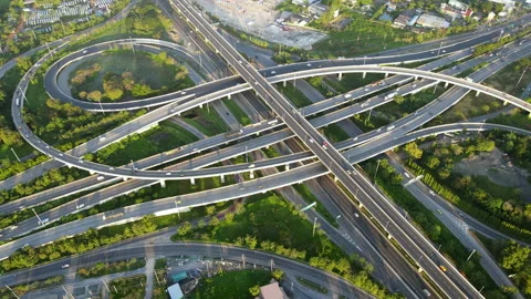 Aerial view of road interchange or highway intersection with cars speeding Stock Footage 148813370