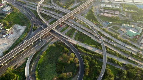 Aerial view of road interchange or highway intersection with cars speeding Stock Footage 148813499