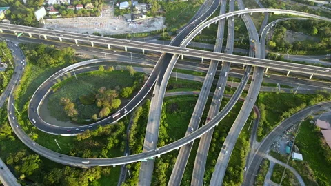 Aerial view of road interchange or highway intersection with cars speeding Stock Footage 148813518