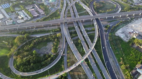 Aerial view of road interchange or highway intersection with cars speeding Stock Footage 148813524