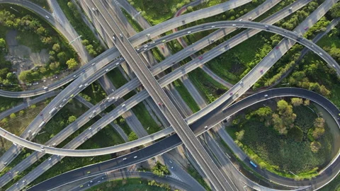 Aerial view of road interchange or highway intersection with cars speeding Stock Footage 148838241
