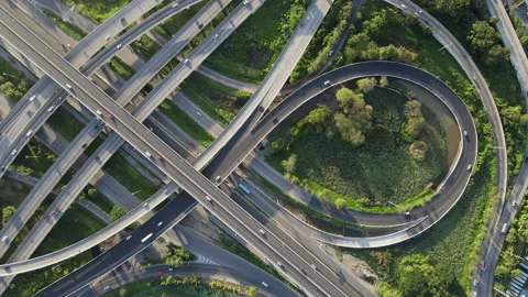 Aerial view of road interchange or highway intersection with cars speeding Stock Footage 148838799