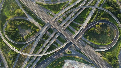 Aerial view of road interchange or highway intersection with cars speeding Stock Footage 148839822