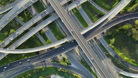 Aerial view of road interchange or highway intersection with cars speeding Stock Footage 148840553