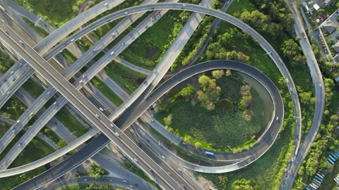 Aerial view of road interchange or highway intersection with cars speeding Stock Footage 148841830