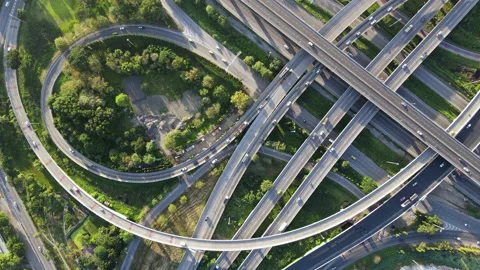 Aerial view of road interchange or highway intersection with cars speeding Video stock 149485943