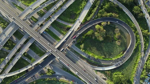 Aerial view of road interchange or highway intersection with cars speeding Video stock 149486210