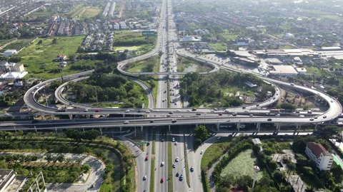 Aerial view of road interchange or highway intersection with cars speeding Video stock 149544915