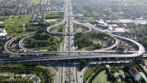 Aerial view of road interchange or highway intersection with cars speeding Video stock 149546328