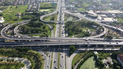 Aerial view of road interchange or highway intersection with cars speeding Video stock 149558409