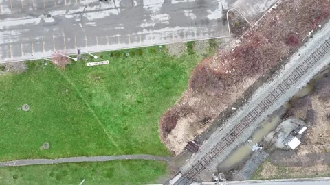 An aerial view of a road intersecting with railway tracks Stock Footage 305293057