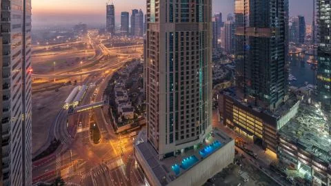 Aerial view of a road intersection in a big city night to day timelapse. Stock-Fotos