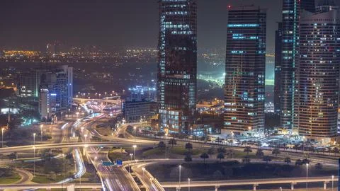 Aerial view of a road intersection in a big city night timelapse. Stock Photos