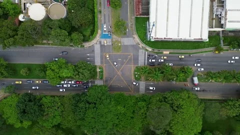 Aerial View of Road Intersection with Green Urban Landscape and Traffic Flow Stock Footage 307974184