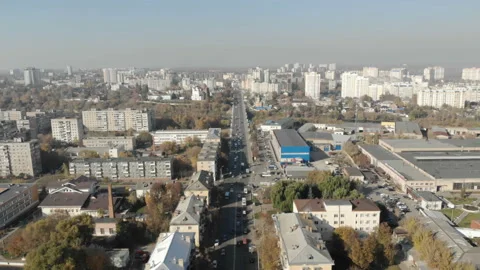 Aerial view of road junction with moving cars and railway tracks on which the Stock Footage 101009748