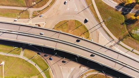 Aerial view of road junction with moving cars at noon. Taken by drone Stock Footage 104932050