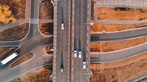Aerial view of road junction with moving cars and railway tracks at sunset Stock Footage 104932217