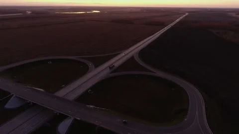 Aerial view. Road junction at sunset. Trucks are driving on the highway. Cars Stock-Footage 197330099